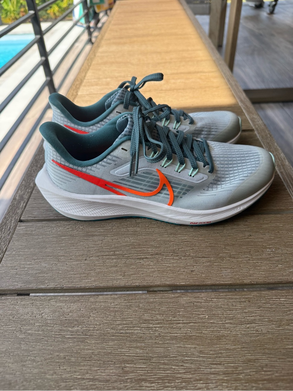 Nike women’s 7.5 Light Gray and green zoom Running Shoes with Orange Swoosh